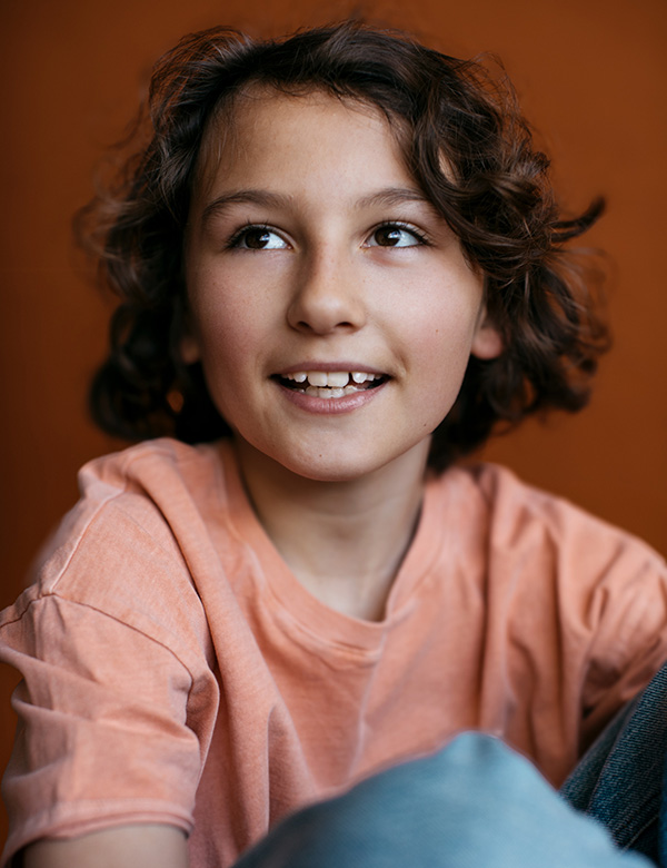 Kinderlijk model met bruin krullend haar Raff Sl.
