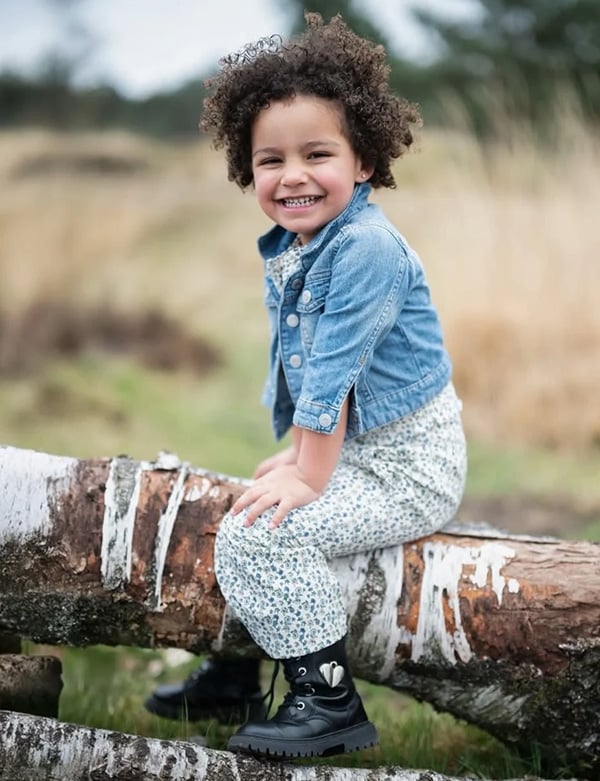 Kinderlijk model met donkerbruin kroes haar en bruine ogen Nadine Noor.